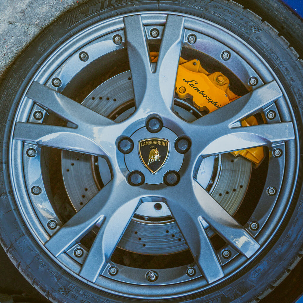 lamborghini wheel with tyre brake disc with yellow brake caliper and logo