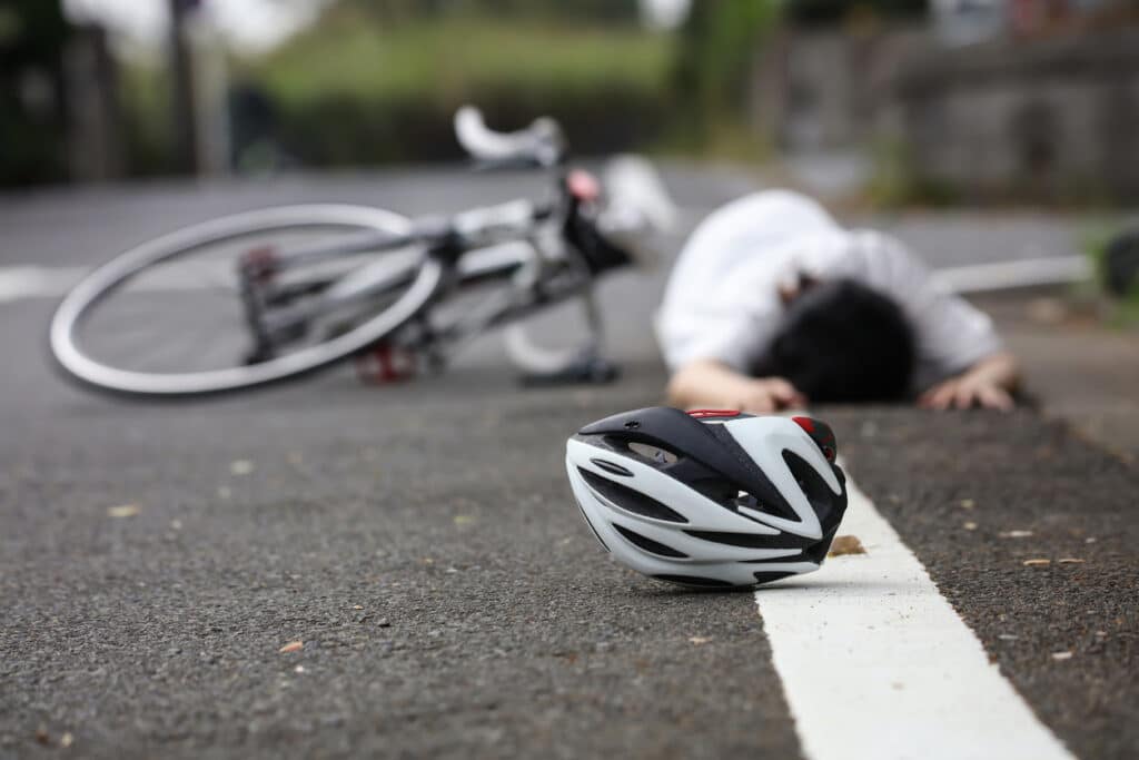 A fallen person after a bicycle accident.