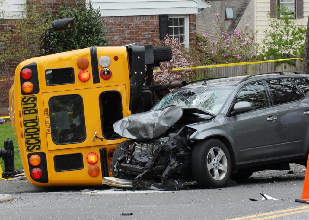 A car and a school bus collided in an accident causing the bus to overturn.