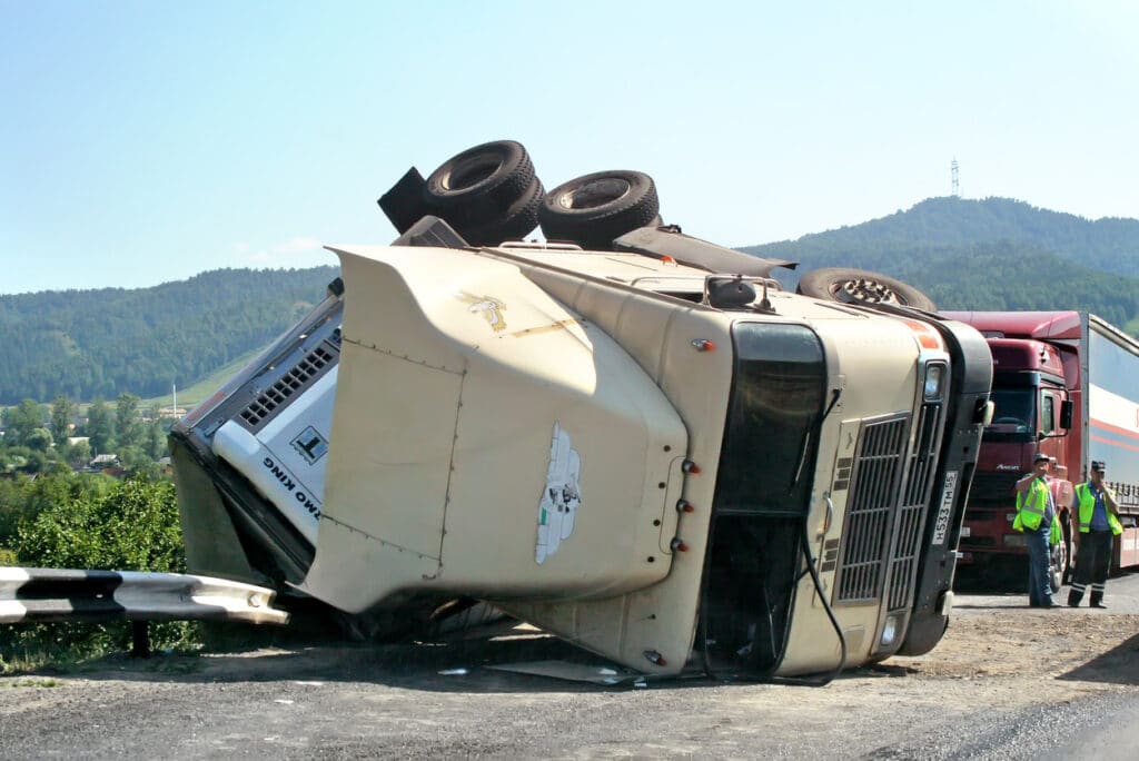 Beige hard truck International 9800 crashed on the freeway.