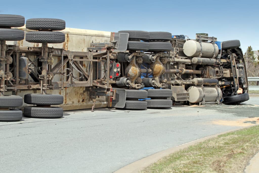 Trucking accident resulting in a big rig on its side.