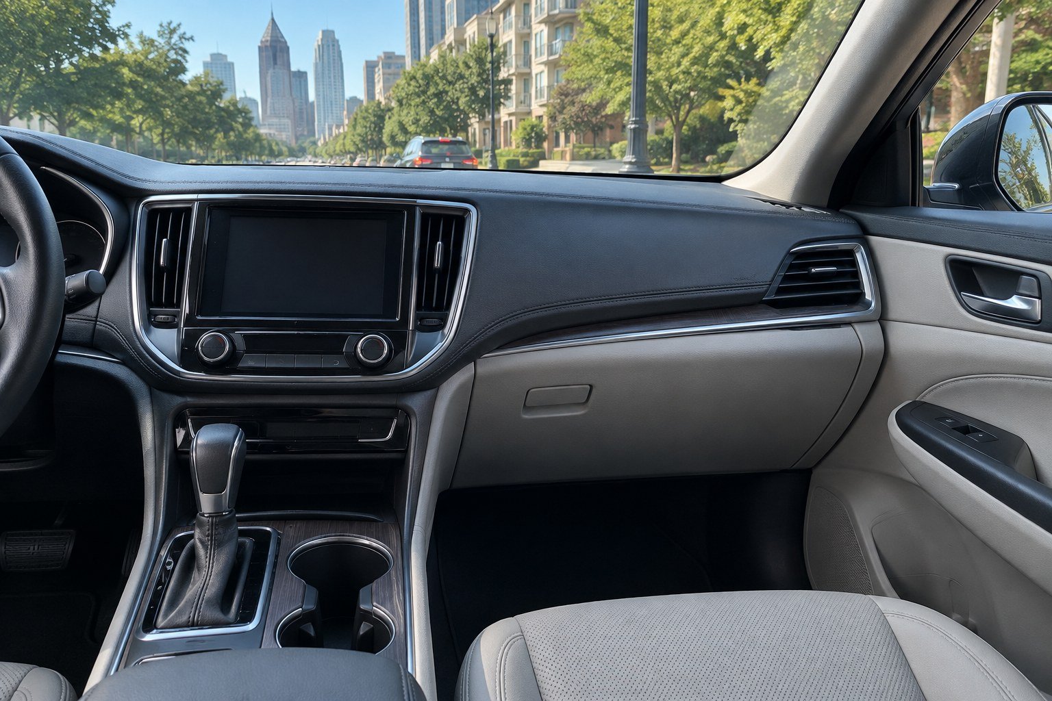 Closed glove compartment and center console inside a sedan parked on an Atlanta street